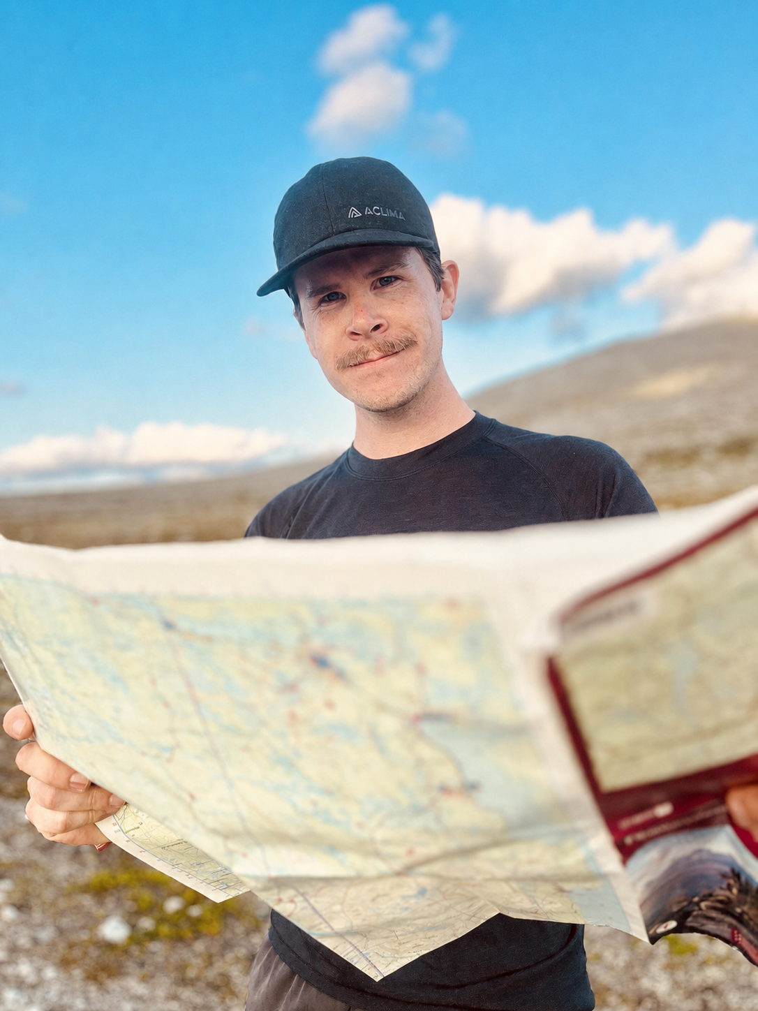 Portrait of Bjørn Torleiv Wahl holding a map outdoors